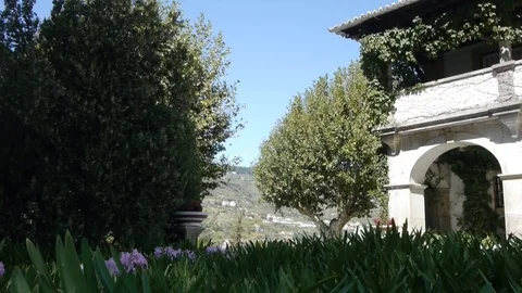 White arch, view of the hills, trees and front garden. Stock Footage 80248810