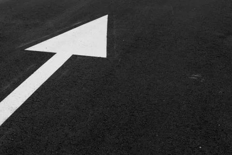 White arrow on asphalt to define direction Stock Photos