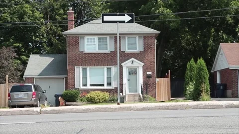 White arrow on black background road traffic sign on post on island with cars Stock Footage 248253000