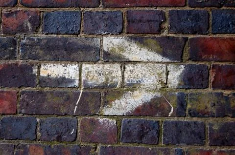 White arrow on a brick wall Stock Photos
