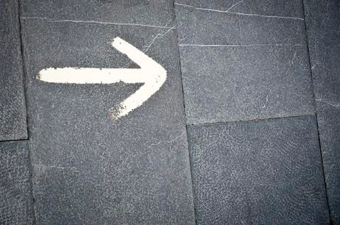 The White arrow on the floor background Stock Photos