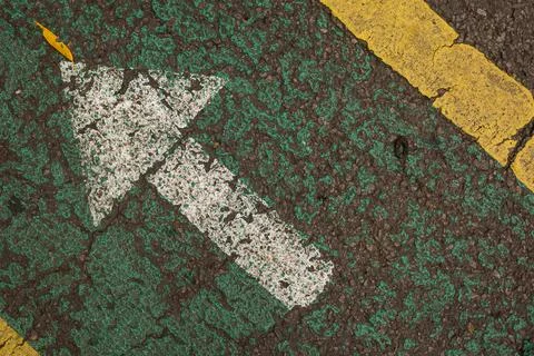 White arrow painted on the ground Stock Photos
