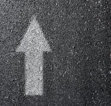 White arrow on surface traffic. 스톡 사진