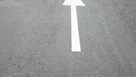 White arrow on tarmac surface Stock Footage 159464726