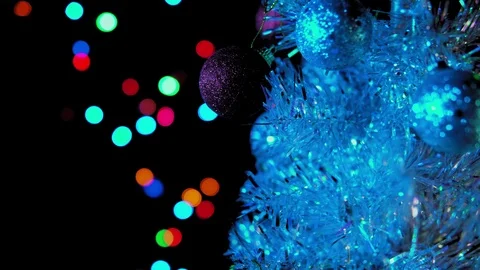 White artificial christmas tree with balls rotates on a black background. Stock Footage 98969375