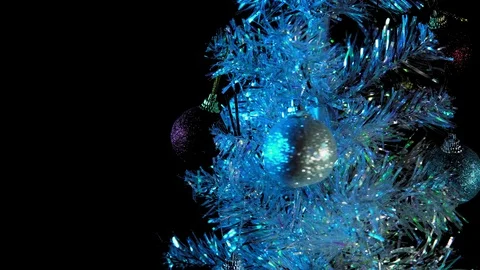 White artificial christmas tree with balls rotates on a black background. Stock Footage 98969426