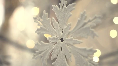 White artificial snowflake decorated with shiny powder on leafless tree Stockbeeldmateriaal 100234513