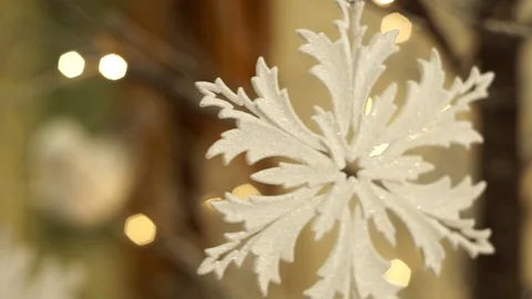 White artificial snowflake decorated with shiny powder on leafless tree Stockbeeldmateriaal 100234517