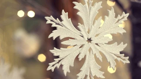White artificial snowflake decorated with shiny powder on leafless tree Stockbeeldmateriaal 100234520