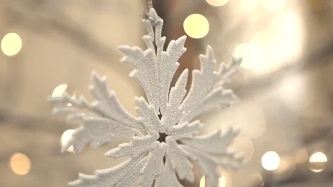 White artificial snowflake decorated with shiny powder on leafless tree Stockbeeldmateriaal 100234650