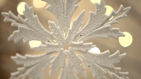 White artificial snowflake decorated with shiny powder on leafless tree Stockbeeldmateriaal 100288930