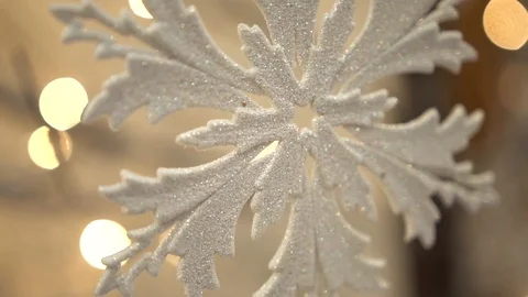 White artificial snowflake decorated with shiny powder on leafless tree Stockbeeldmateriaal 100288931