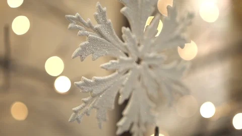 White artificial snowflake decorated with shiny powder on leafless tree Stockbeeldmateriaal 100288949