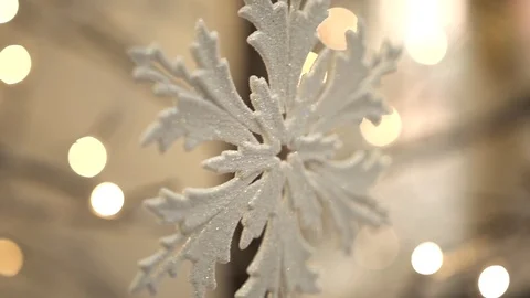White artificial snowflake decorated with shiny powder on leafless tree Stockbeeldmateriaal 100288956