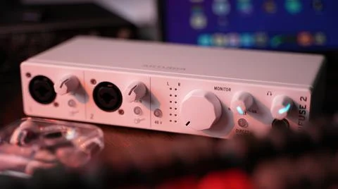 A white Arturia MiniFuse audio interface on a wooden table Stock Photos
