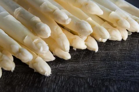 White asparagus on a black background Stock Photos