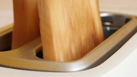 White automatic electric toaster and burned bread pieces 4K video Stock Footage 96692971