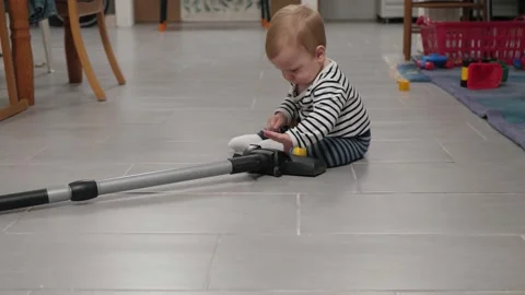 White baby exploring vacuum nozzle Stock Footage 337229027