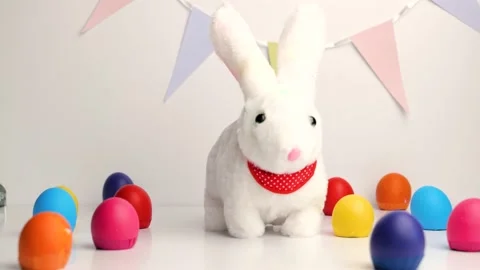 White baby rabbit toy with easter colorful eggs Stock Footage 148862528
