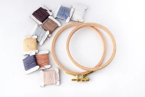 On a white background are cotton threads of different colors wound on bobbins Stock Photos