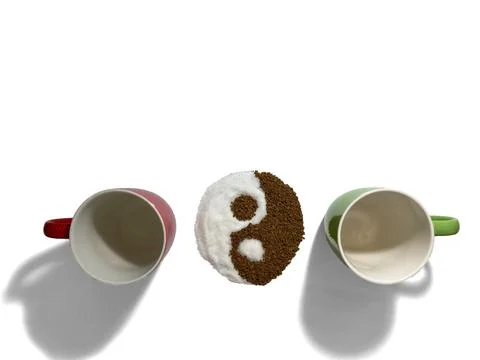 On a white background are two cups, green and red. Between them is a yin yang Stock Photos