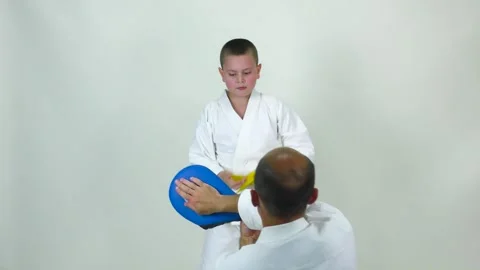 On a white background, the athlete beats kicks and hands on the simulator Stock Footage 246332445