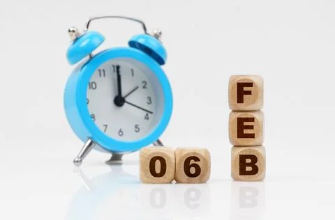 On a white background, a blue alarm clock and a calendar with the inscripti.. Stock Photos