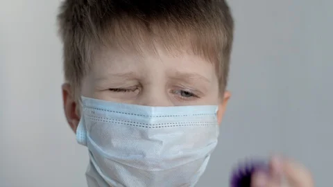 On a white background, a boy puts balloons like a coronavirus instead of eyes Stock Footage 128057103