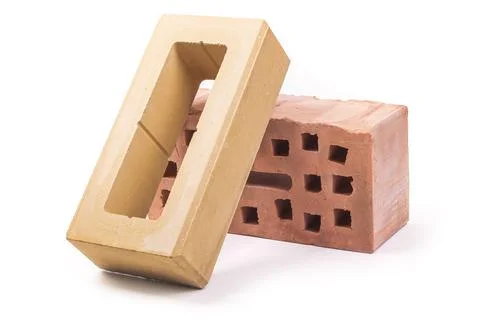 White background. the brick was made of clay. there are holes. close-up. 스톡 사진