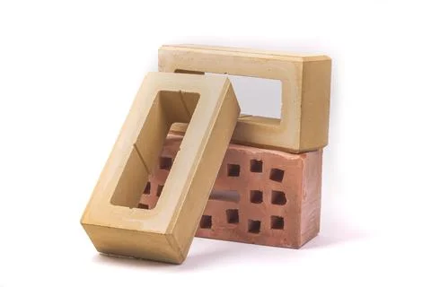 White background. the brick was made of clay. there are holes. close-up. 스톡 사진
