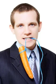 White background business person dangling a carrot Stock Photos
