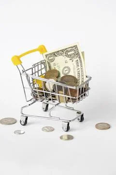 On a white background, a cart full of different money Stock Photos