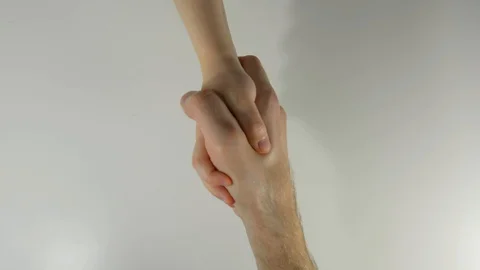 On a white background the children's hand greets with the hand of an adult man. Stock Footage 128692421