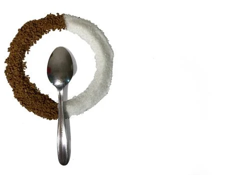 On a white background is a circle, there is a teaspoon in the center. Stock Photos