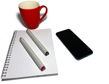 On a white background is a clean notebook with two markers for drawing. Stock Photos