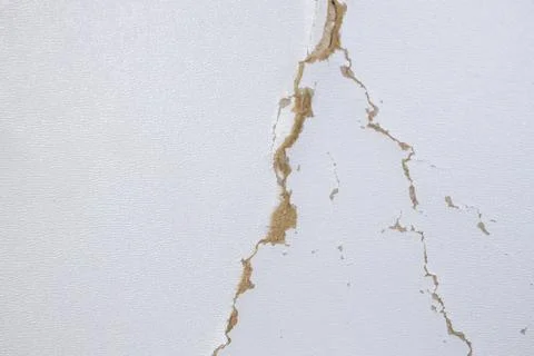 White background with cracks. Torn cracks on the texture. Textured space fo.. Stock Photos