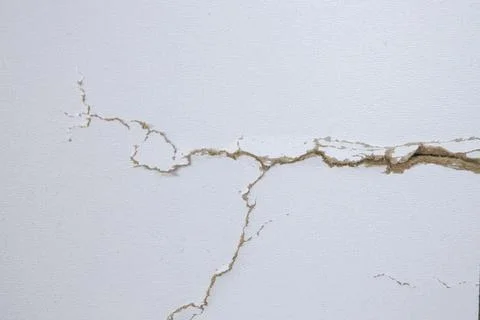 White background with cracks. Torn cracks on the texture. Textured space fo.. Stock Photos