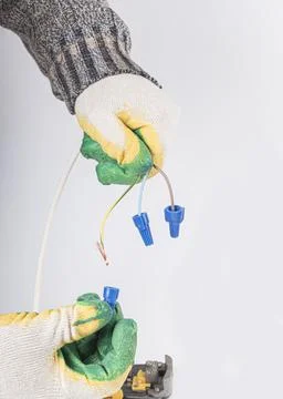 White background. electrical wires. the master removes the insulation with th Stock Photos