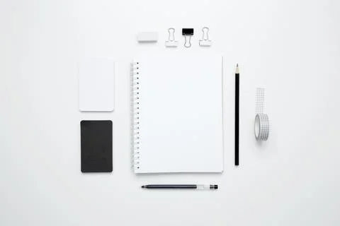 On a white background, an empty mock up notebook, white and black cards, and  Stock Photos