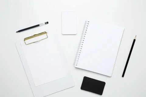 On a white background, an empty mock up notebook and clipboard, white and bla Stock Photos