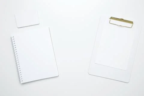 On a white background, an empty mock up notebook and clipboard, white and bla Stock Photos