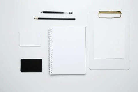 On a white background, an empty mock up notebook and clipboard, white and bla Stock Photos