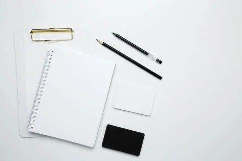 On a white background, an empty mock up notebook and clipboard, white and bla Stock Photos