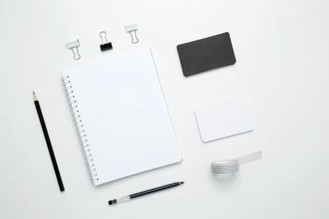 On a white background, an empty mock up notebook, white and black cards, and  Stock Photos