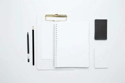 On a white background, an empty mock up notebook and clipboard, white and bla Stock Photos