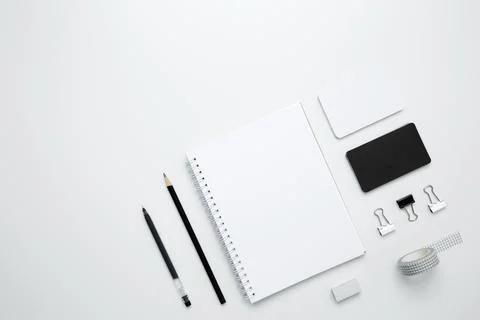 On a white background, an empty mock up notebook, white and black cards, mono Stock Photos