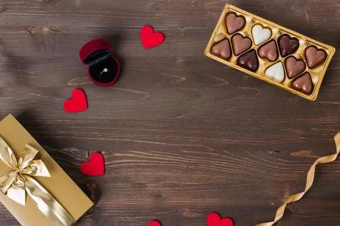White background with gift boxes, chocolate candies and small red hearts. Con Stock Photos