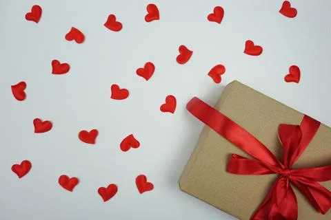 On a white background is a gift with a red bow Stock Photos