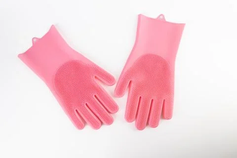 On white background lie large thick rubber pink gloves with texture for easy Stock Photos