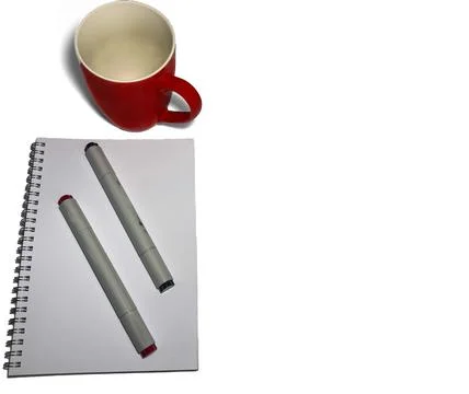 On a white background lies a blank notebook for drawing. It has two markers Stock Photos